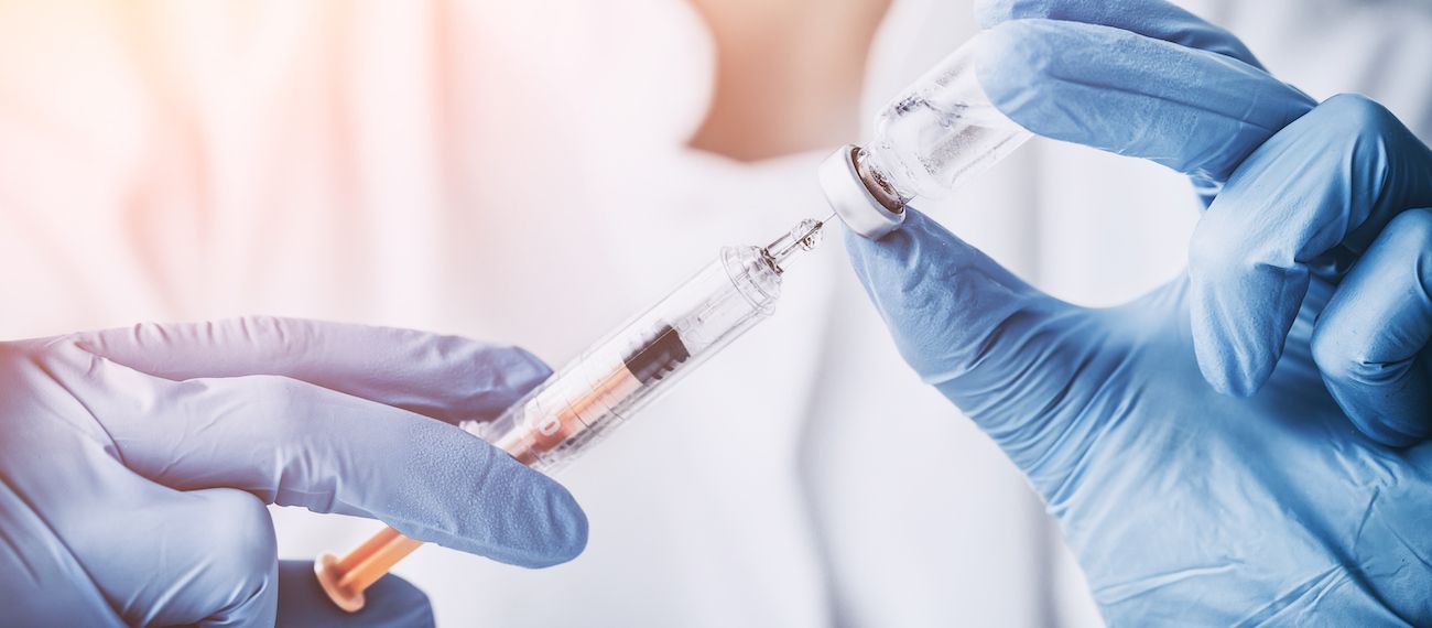 hands holding a syringe