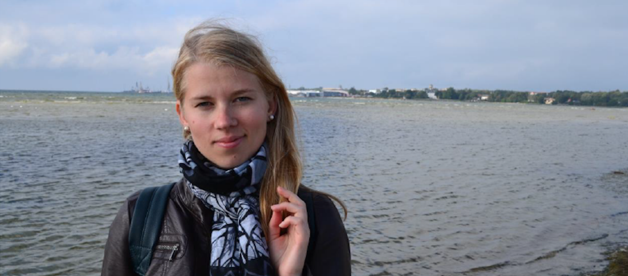 a woman with sea in the background